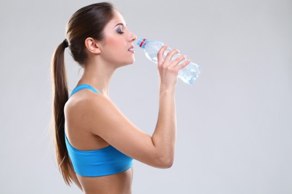 young girl drinking water from bottle